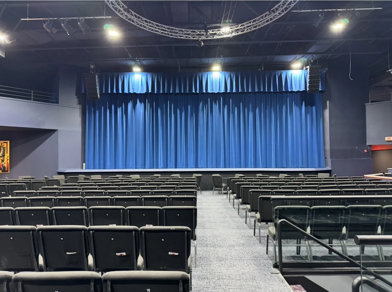 The Londzell auditorium and stage with signature blue curtains